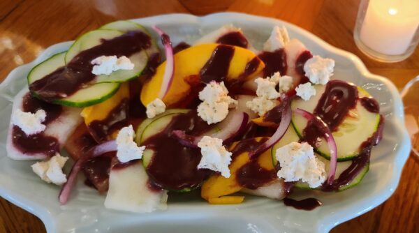 Summer melon salad with cucumber, caramelized red onion, Texas peaches, mint, blueberry and peach vinaigrette.