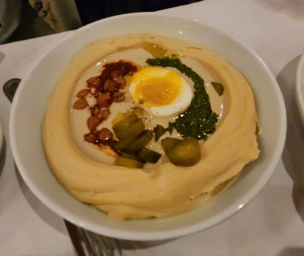 Hummus topped with egg, harissa and pickles