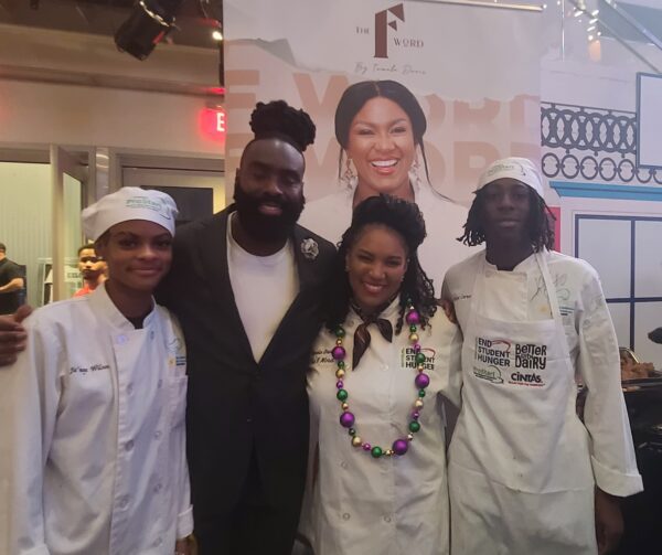 New Orleans Saints Linebacker Demario Davis and his wife, Tamela Gil Davis, owner of The F Word catering, with culinary students.