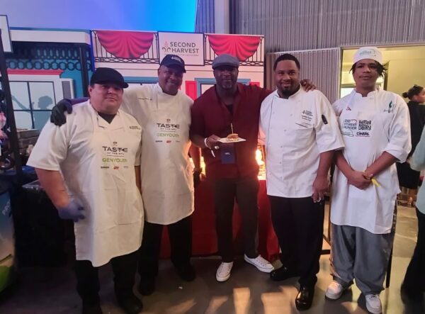 NFL Player Mark “Mighty Mouse” McMillian with the team from Second Harvest