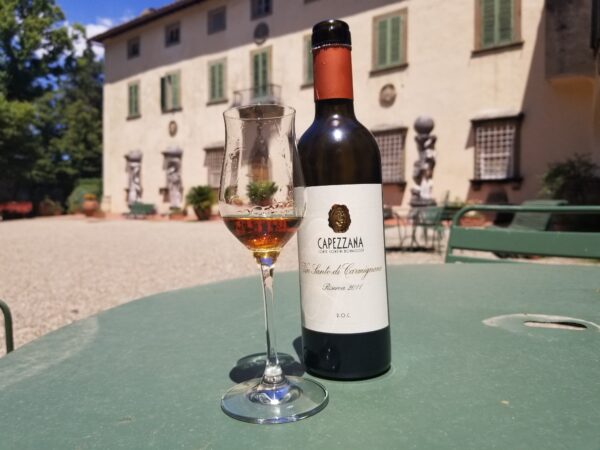 A view of the villa with a glass of Capezzana Vin Santo Riserva 2011 (photo: Melanie Young)