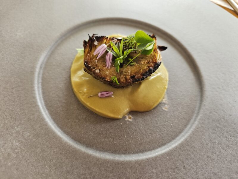 Grilled artichoke heart atop artichoke puree at Osmosi