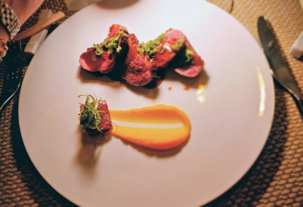 Duck breast a l’orange- tender slices of duck seasoned with honey and kabocha ($12 supplement) paired with Famille Moreau Le Puy Emilion 2022