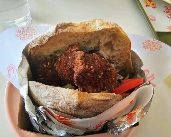 Chicken schnitzel sandwich in pita with pickle, lemon and sesame is destined to be a NOLA top sandwich.