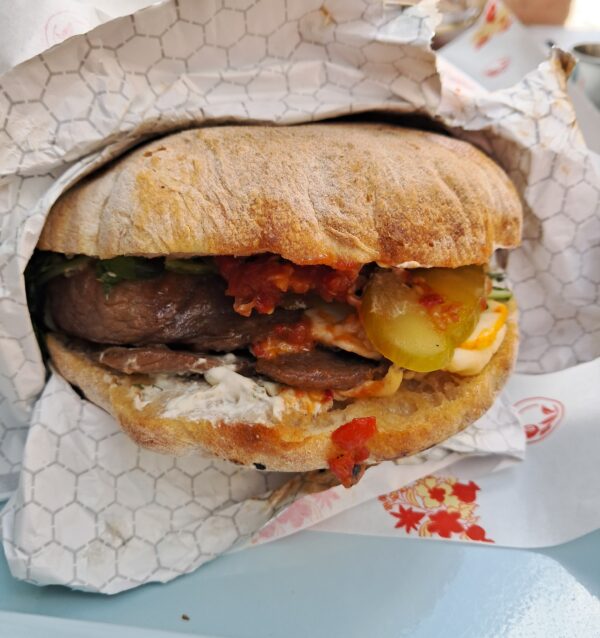 Roasted lamb sandwich with tzatziki and marinated peppers, red onion and arugula was tender and succulent.