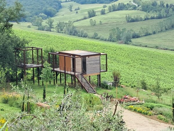An agriturismo, Podere Arcangelo offers different accommodation options, from a villa with a swimming pool to well-appointed modern glamping huts like the in this photo. 