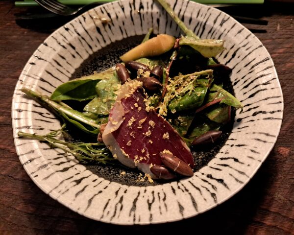 Tiki Farm field greens with duck prosciutto, Tiki Farm cucumber, heirloom carrots, baru nuts, miso cured egg yolk, carrot top and black tahini dressing