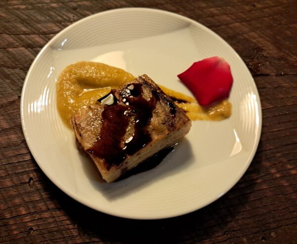 Potato pave with Tiki rose cream, golden tomato sauce, carrot and black garlic gastrique