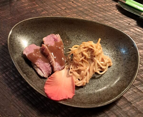 Pekin duck with coffee miso yuzu herb marinade and Tiki Farm green mango slaw