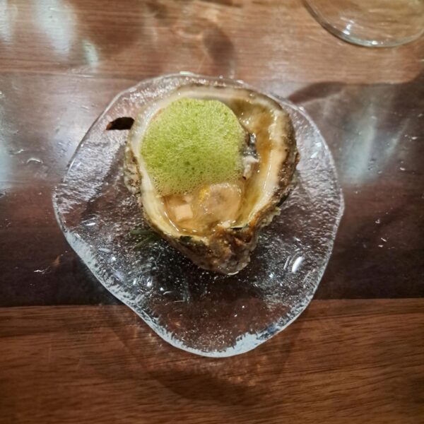 a Bayou Rosa oyster with cucumber foam and lemon zest