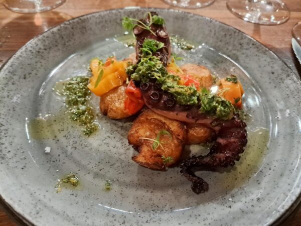 Chargrilled octopus in sweet pepper and mojo verde with crispy smashed potatoes